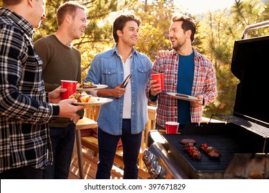 Group Of Gay Male Friends Enjoying Barbeque Together
