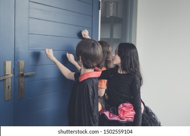 Group Of Girl And Boy Kids Smiling And Dress Up As Halloween Vampire Costume And Knock On Door For Trick Or Treat For Halloween Night Day Theme Coming Soon Together