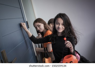 Group Of Girl And Boy Kids Smiling And Dress Up As Halloween Vampire Costume And Knock On Door For Trick Or Treat For Halloween Night Day Theme Coming Soon Together