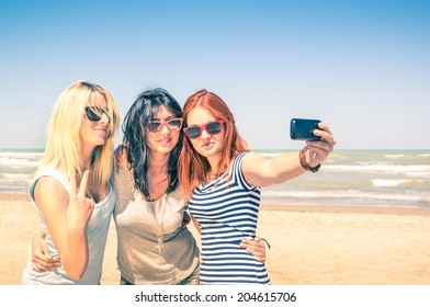 Group Of Girlfriends Taking A Selfie At The Beach - Concept Of Friendship And Fun In The Summer With New Trends And Technology - Best Friends Enjoying The Moment With Modern Smartphone