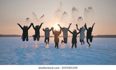 A group of girls friends are throwing snow up at sunset. - Powered by Shutterstock