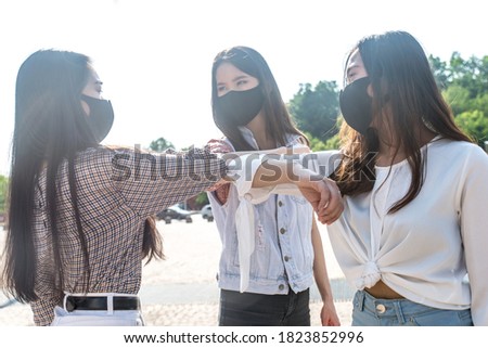 Group of girls going out after quarantine during coronavirus period. Young women outdoor with safety masks