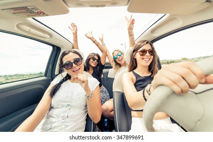 Group Of Girls Having Fun With The Car. Taking Selfie While Driving