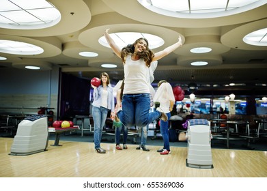 Group Of Girls Having Fun And Play Bowling At Hen Party.