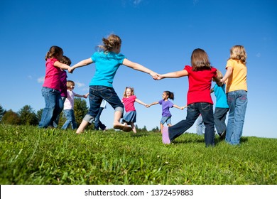 Group of Girls Holding Hands in a Circle Outside - Unity, Friendship