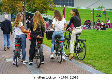 A Group Of Girls On Bicycles In The City Of Amsterdam. Healthy Lifestyle - People Riding Bicycles In City Park. 4 September 2018. Amsterdam. Netherlands.