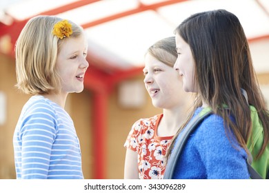 Group Of Girls Talking Outside School Building