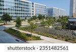 Group of glass office building with nice landscaping and outdoor recreation yard in business center downtown Plano, Texas, USA. Aerial view modern corporate towers in Dallas Fort Worth metro complex