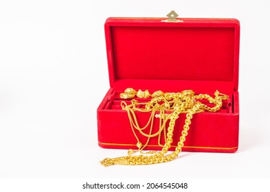 Group Of Gold Necklace And Gold Ring Of Accessories In Red Box On White Background.