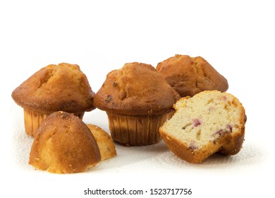 A Group Of Golden Lemon Cranberry Muffins And A Cut Muffin Isolated On White