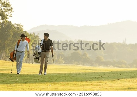 Group golf professional Golfer asian man walking in fairway with bag golf at golf  club.  Hobby in holiday and vacation with friends.  Lifestyle and Sport Concept