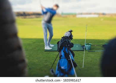 Group Of Golfers Practicing And Training Golf Swing On Driving Range Practice, Men Playing On Golf Course, Golf Ball At Golfing Complex Club Resort 