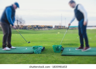 Group Of Golfers Practicing And Training Golf Swing On Driving Range Practice, Men Playing On Golf Course, Golf Ball At Golfing Complex Club Resort 