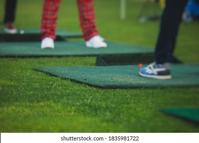 Group Of Golfers Practicing And Training Golf Swing On Driving Range Practice, Men Playing On Golf Course, Golf Ball At Golfing Complex Club Resort 