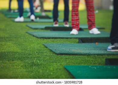 Group Of Golfers Practicing And Training Golf Swing On Driving Range Practice, Men Playing On Golf Course, Golf Ball At Golfing Complex Club Resort 