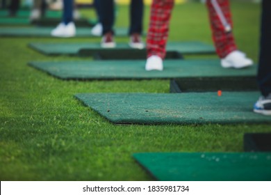 Group Of Golfers Practicing And Training Golf Swing On Driving Range Practice, Men Playing On Golf Course, Golf Ball At Golfing Complex Club Resort 