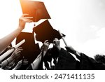 Group of graduate students throwing graduation hats to the sky.