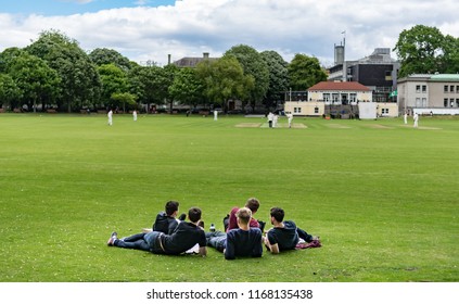 Group Of Guys Watching A Cricket Match