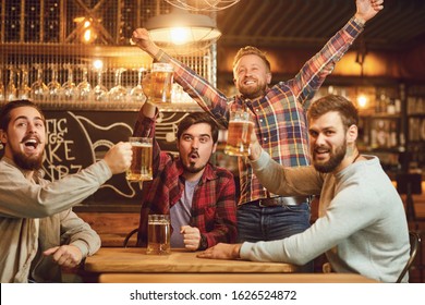 A Group Of Guys Watching Sports On Tv In A Pub Bar.