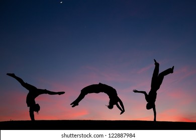 Group Of Gymnasts Tumbling In Sunset