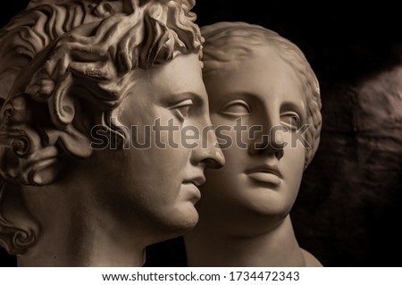 Group gypsum busts of ancient statues human heads for artists on a dark background. Plaster sculptures of antique people faces. Renaissance epoch style. Academic subject. Blank for creativity.