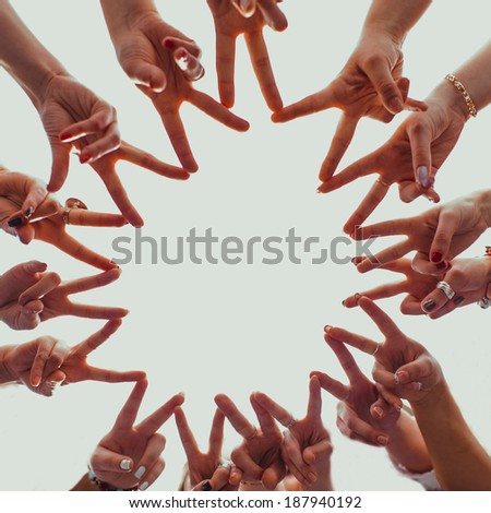 Group of hands forming a star shape 