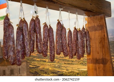 Group Of Hanging Salami Inside Butcher Shop.