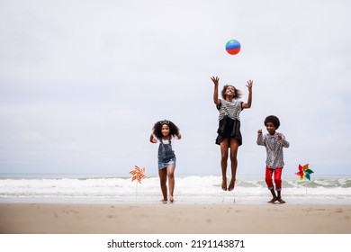Group Of Happy African American Children Jumping On A Tropical Beach. Ethnically Diverse Concept