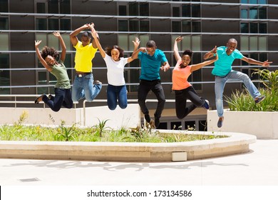 group of happy african college students jumping high