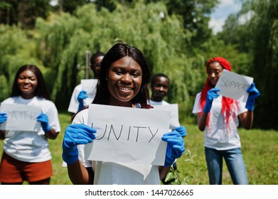 Group of happy african volunteers hold blank board with unity sign in park. Africa volunteering, charity, people and ecology concept. - Shutterstock ID 1447026665