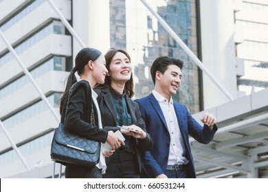 Group Of Happy Asian Business Colleagues Laughing And Talking Enjoy Outside The Office.