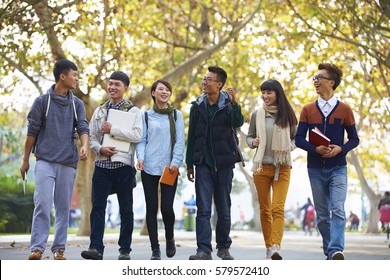 Group Of Happy Asian College Students Walking Together In The Campus