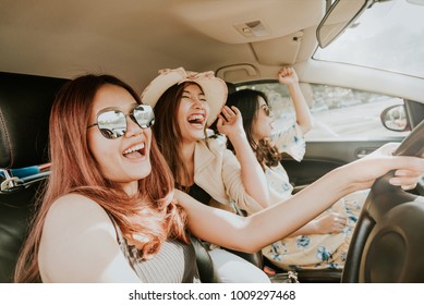 Group Of Happy Asian Girl Best Friends Laughing And Smiling In Car During A Road Trip To Vacation.