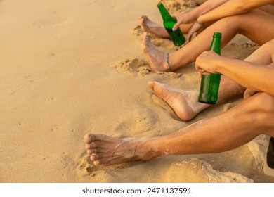 Group of Happy Asian man and woman enjoy and fun outdoor lifestyle travel nature at the sea on summer beach holiday vacation. People friends relaxing and drinking beer together on the beach at sunset. - Powered by Shutterstock