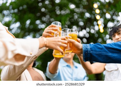 Group of Happy Asian millennial generation people friends enjoy and fun toasting beer glasses celebration reunion meeting at outdoor dinner party in the garden at restaurant on holiday vacation. - Powered by Shutterstock