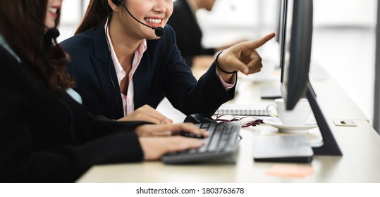 Group Of Happy Asian Smiling Call Center Business Operator Customer Support Team Phone Services Agen Working And Talking With Headset On Desktop Computer At Call Center