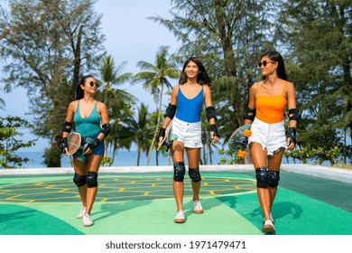 Group of Happy Asian woman girl friends carry skateboard walking with talking together at skateboard park. Female friendship enjoy outdoor activity lifestyle play extreme sport surf skate together - Powered by Shutterstock