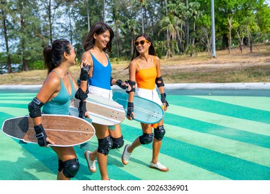 Group Of Happy Asian Woman Girl Friends Carry Skateboard Walking With Talking Together At Skateboard Park. Female Friendship Enjoy Outdoor Activity Lifestyle Play Extreme Sport Surf Skate Together