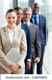 Group Of Happy Business Executives Standing In A Row