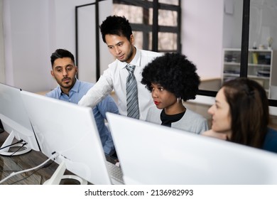 Group Of Happy Business People Using Laptop Discussing At Workplace In Office - Shutterstock ID 2136982993
