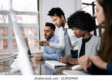 Group Of Happy Business People Using Laptop Discussing At Workplace In Office - Shutterstock ID 2139359969