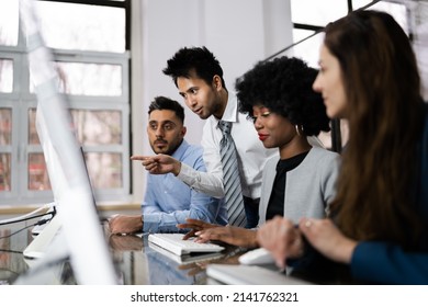 Group Of Happy Business People Using Laptop Discussing At Workplace In Office - Shutterstock ID 2141762321