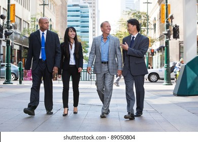 Group Of Happy Business People Walking Together On Street