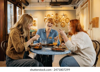 Group of happy cheerful friends having lunch in the restaurant - Powered by Shutterstock