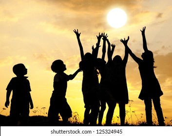 Group of happy children catching sun with their arms