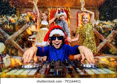 Group Of Happy Children Is Having A Party Near The House Of Santa Claus Decorated With Lights. Christmas Party Concept.