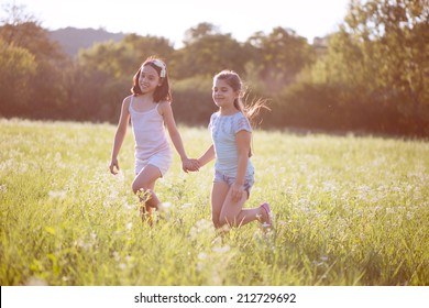 Group Of Happy Children Playing On Meadow