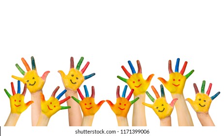 Group of happy children raises hands up. Children's hands with painted colorful palms and painted smiling faces. Joy, success, school, education, happy childhood concept. Isolated on white background.