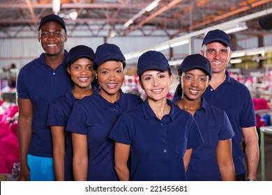 group of happy clothing factory workers inside production area