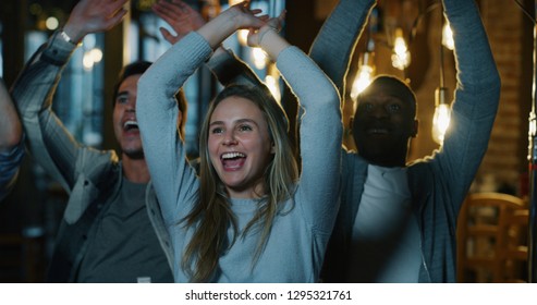 Group Of Happy College Friends  Cheering Together In A Pub.  Concept Of Football Fans, Friendship, Sports